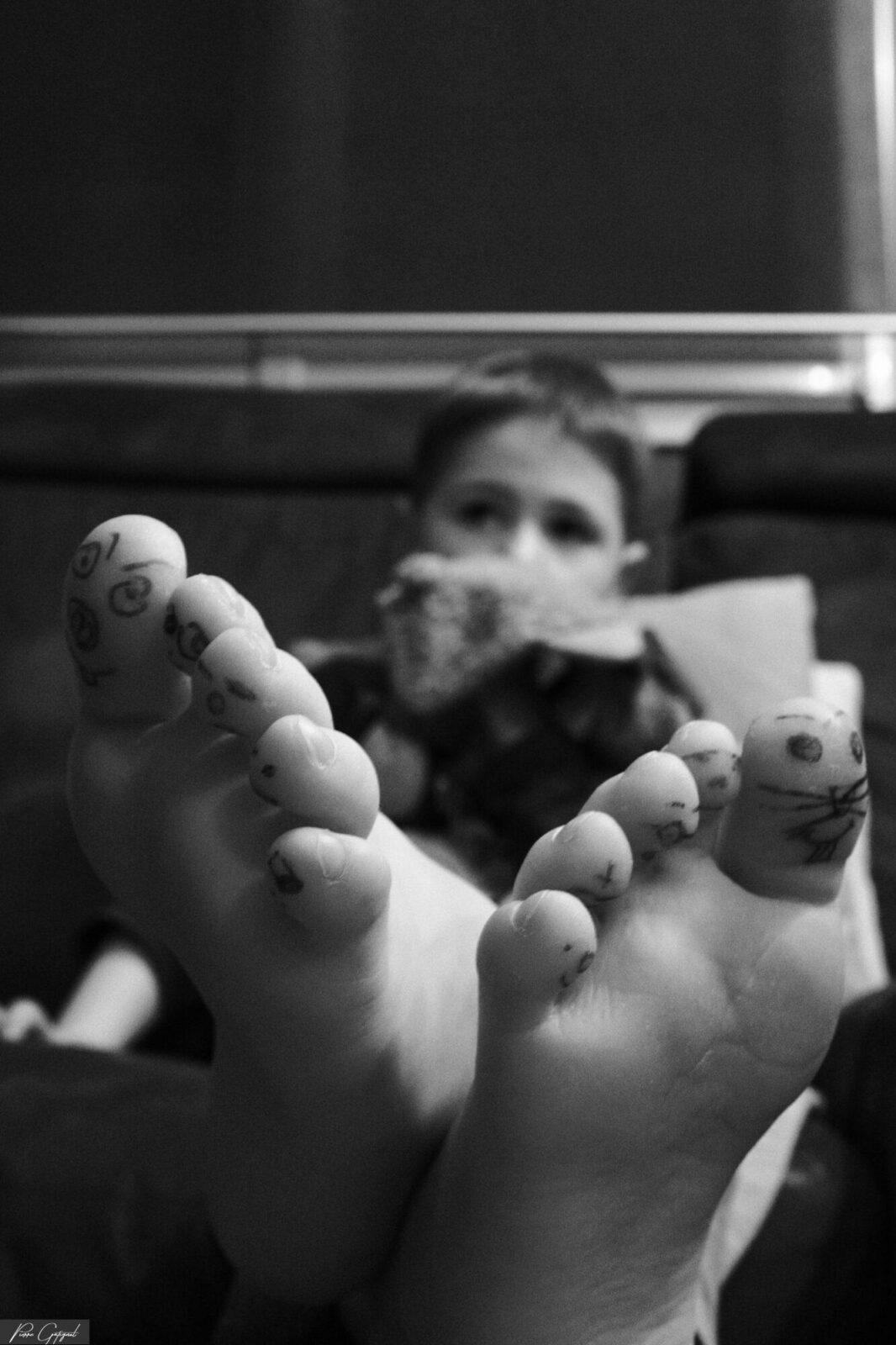Pieds d’un enfant dessinés au feutre au premier plan